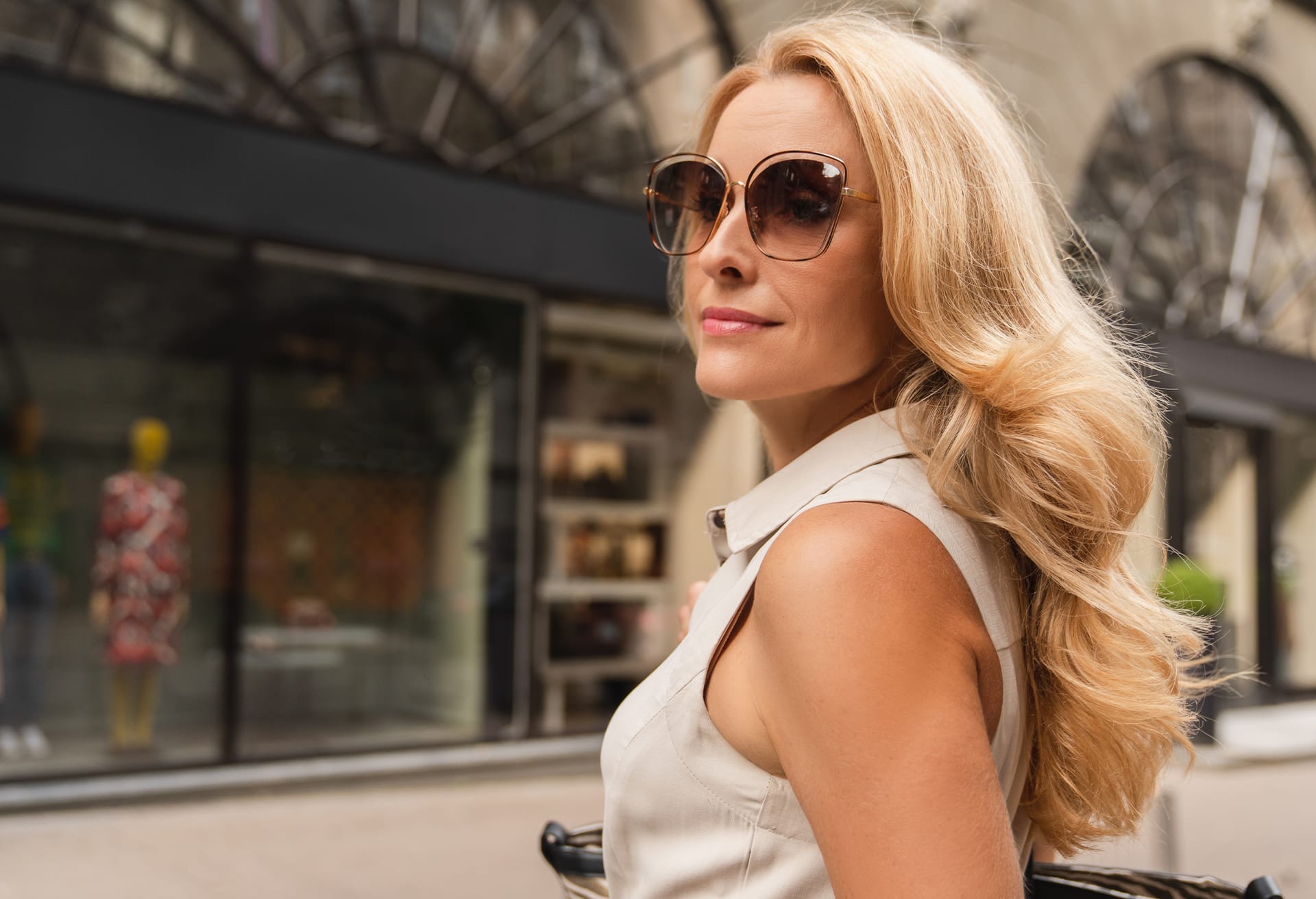 Woman with blonde hair wearing large sunglasses