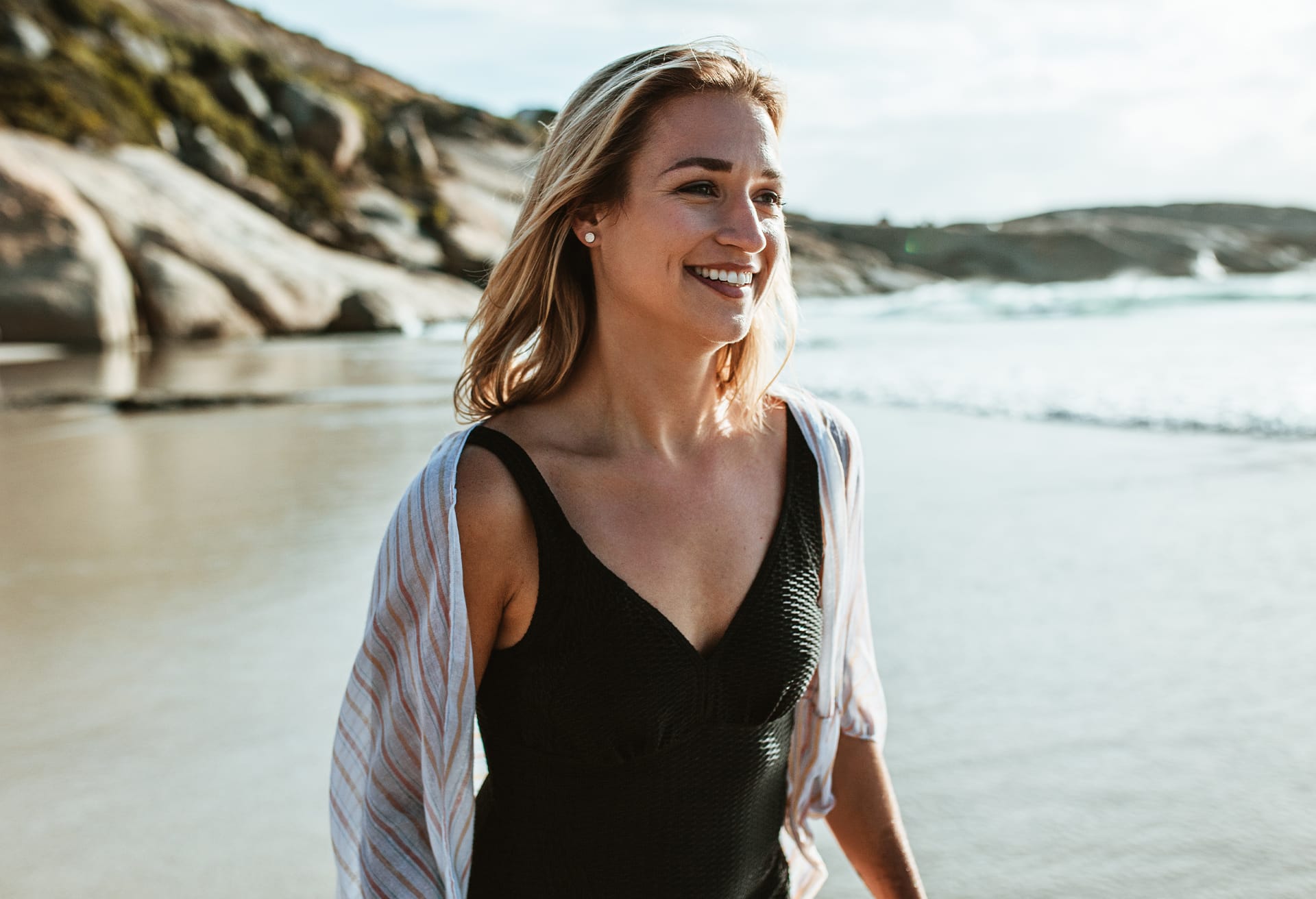 Blonde-haired woman in a black one-piece swimsuit