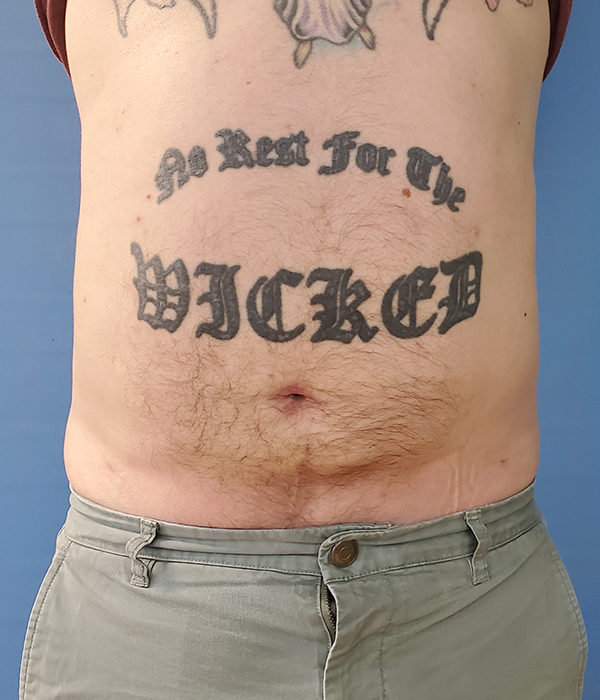 Tattooed torso with the text "No Rest For The WICKED" on the stomach